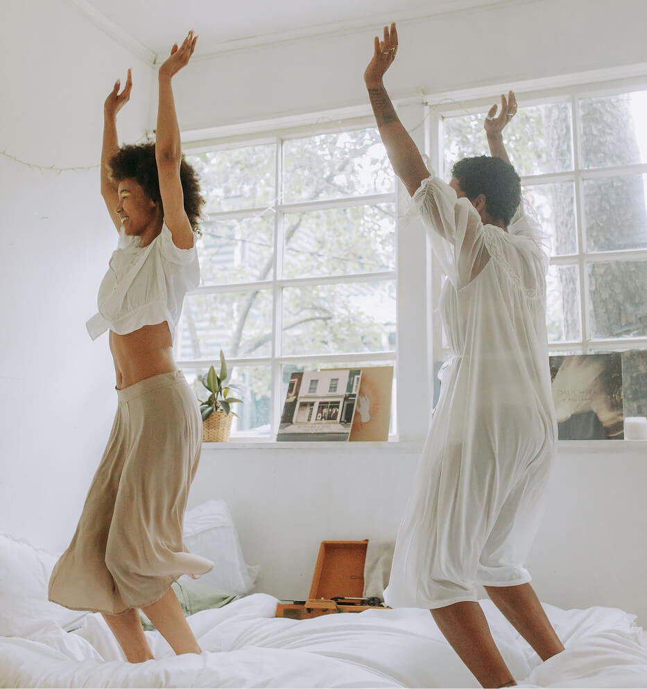 children jumping on bed