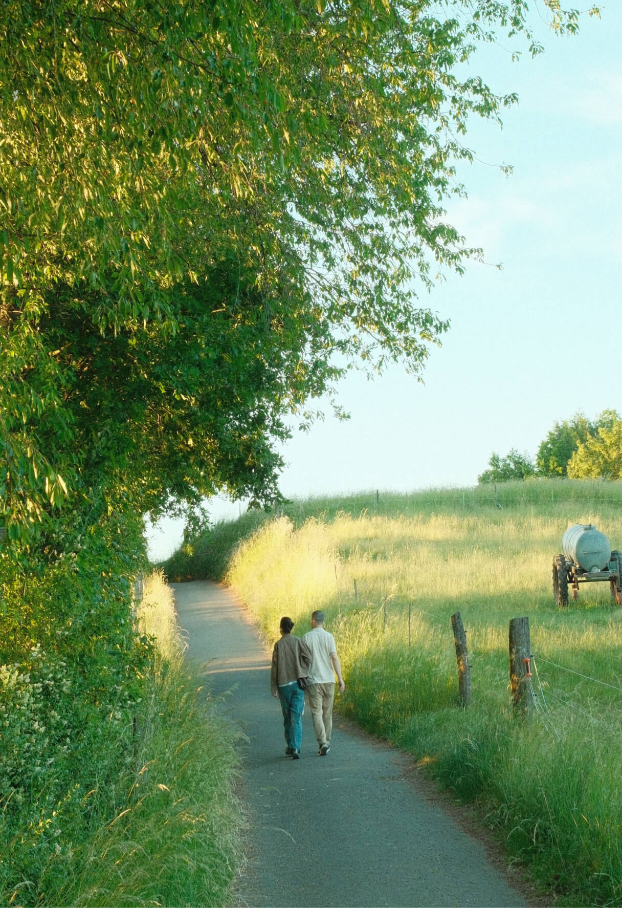 couple walking down a path through farmland