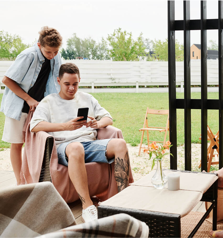 man and child looking at phone
